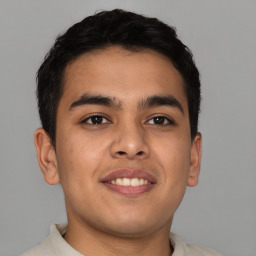 Joyful asian young-adult male with short  brown hair and brown eyes