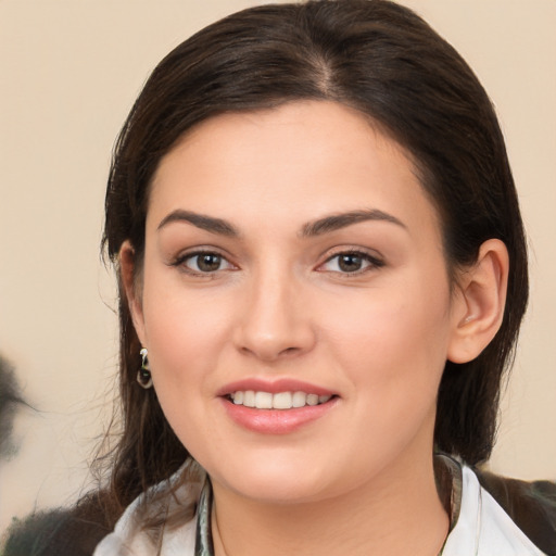 Joyful white young-adult female with medium  brown hair and brown eyes