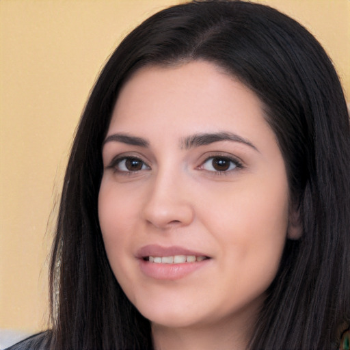 Joyful white young-adult female with long  black hair and brown eyes