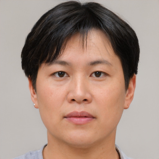 Neutral asian adult female with short  brown hair and brown eyes