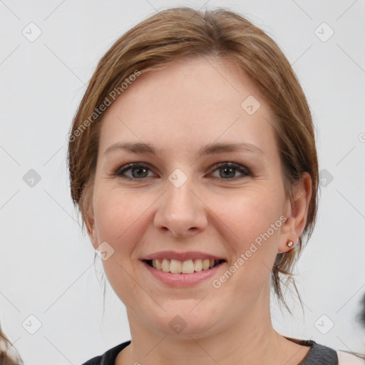 Joyful white young-adult female with medium  brown hair and grey eyes