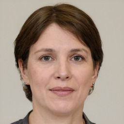 Joyful white adult female with medium  brown hair and grey eyes