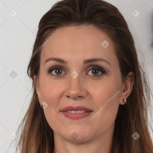 Joyful white adult female with long  brown hair and brown eyes