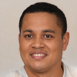 Joyful latino young-adult male with short  brown hair and brown eyes
