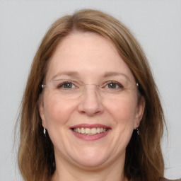 Joyful white adult female with medium  brown hair and grey eyes