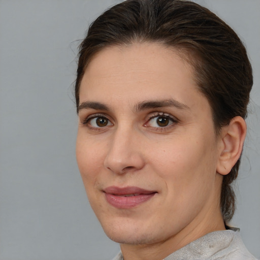 Joyful white young-adult female with medium  brown hair and brown eyes