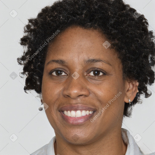 Joyful black adult female with short  brown hair and brown eyes