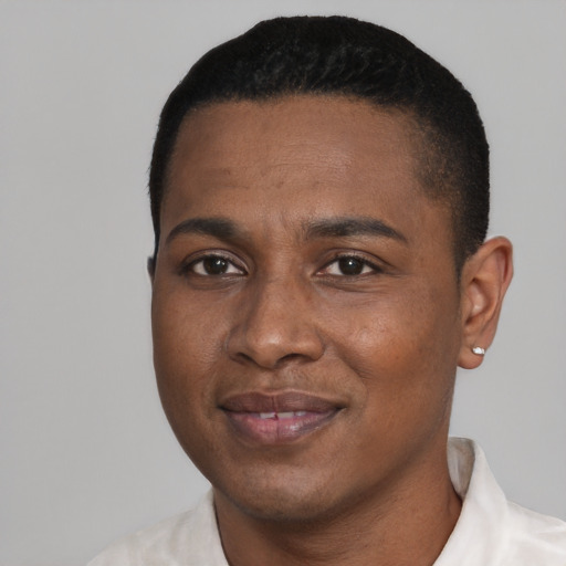 Joyful black adult male with short  black hair and brown eyes