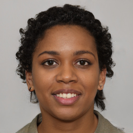 Joyful black young-adult female with short  brown hair and brown eyes