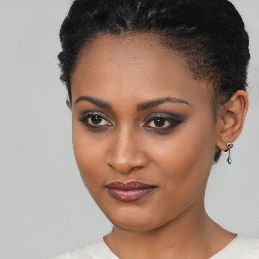 Joyful black young-adult female with short  brown hair and brown eyes