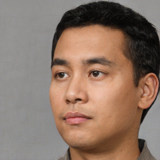 Neutral latino young-adult male with short  black hair and brown eyes