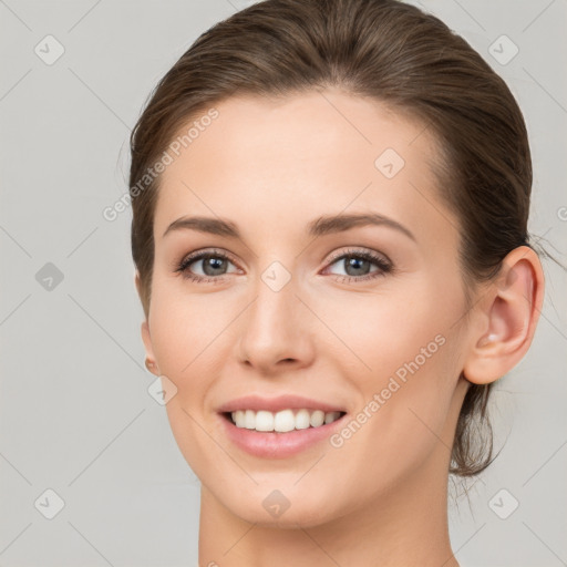 Joyful white young-adult female with medium  brown hair and grey eyes