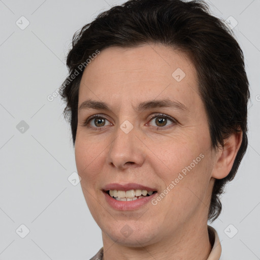 Joyful white adult female with short  brown hair and brown eyes