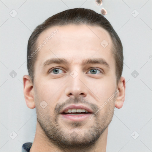 Joyful white young-adult male with short  brown hair and grey eyes