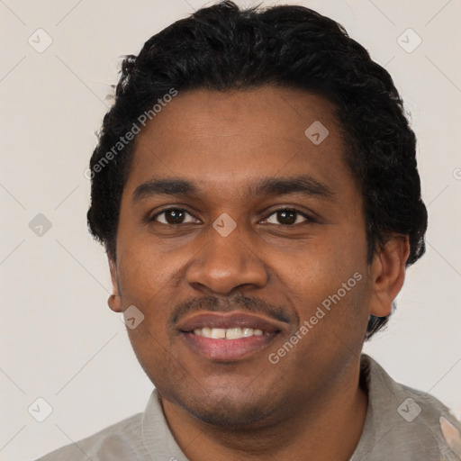 Joyful black young-adult male with short  black hair and brown eyes