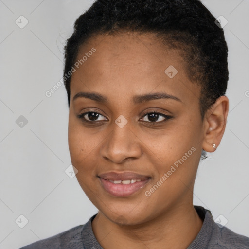 Joyful black young-adult female with short  black hair and brown eyes