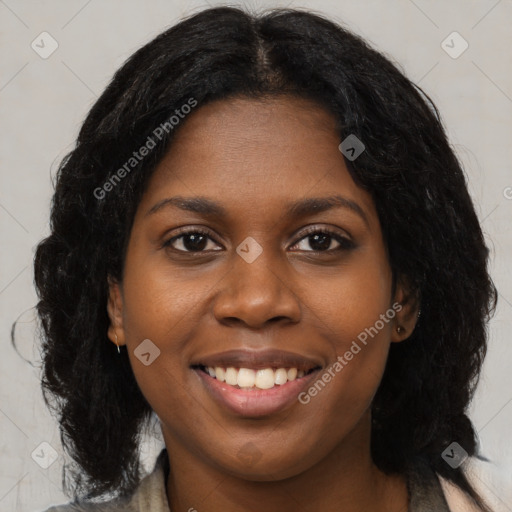 Joyful black young-adult female with long  brown hair and brown eyes