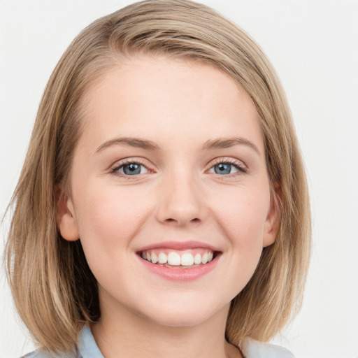 Joyful white young-adult female with medium  brown hair and blue eyes