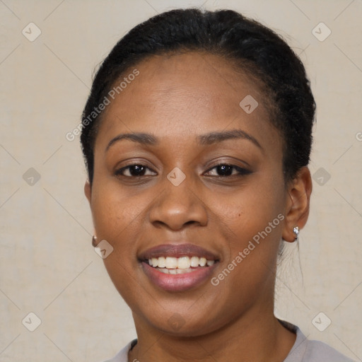 Joyful black young-adult female with short  black hair and brown eyes