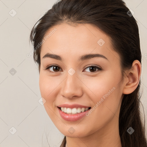 Joyful white young-adult female with long  brown hair and brown eyes