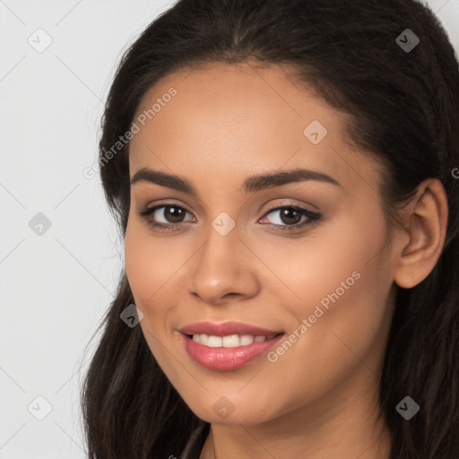 Joyful latino young-adult female with long  brown hair and brown eyes