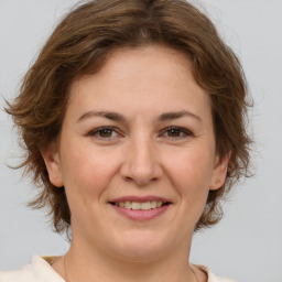 Joyful white adult female with medium  brown hair and brown eyes