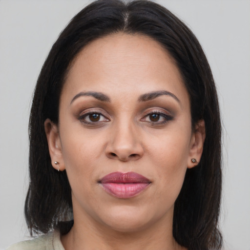 Joyful latino young-adult female with medium  brown hair and brown eyes