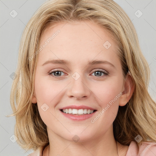 Joyful white young-adult female with medium  brown hair and blue eyes