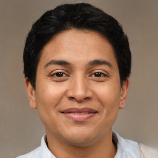 Joyful latino adult male with short  black hair and brown eyes