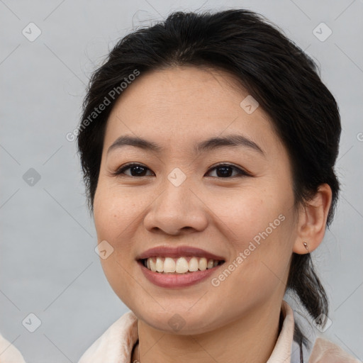 Joyful asian young-adult female with medium  brown hair and brown eyes