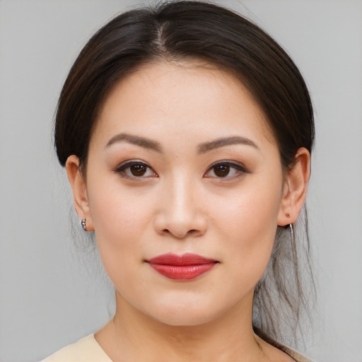 Joyful asian young-adult female with medium  brown hair and brown eyes
