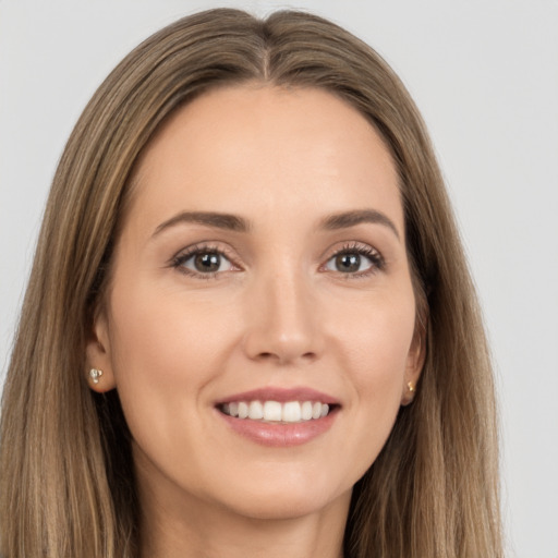 Joyful white young-adult female with long  brown hair and brown eyes