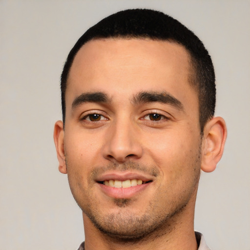 Joyful white young-adult male with short  black hair and brown eyes