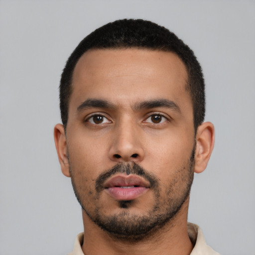 Neutral latino young-adult male with short  black hair and brown eyes