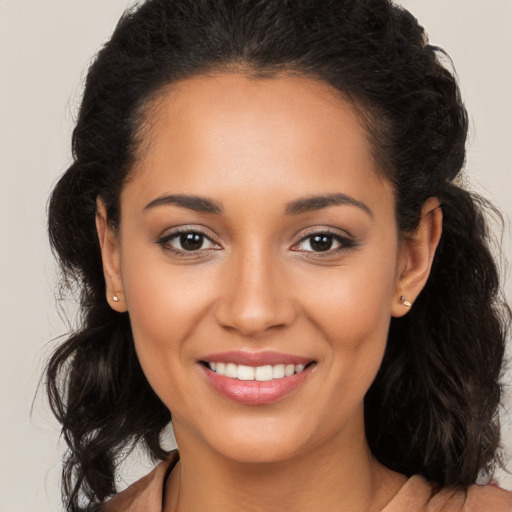 Joyful latino young-adult female with long  brown hair and brown eyes