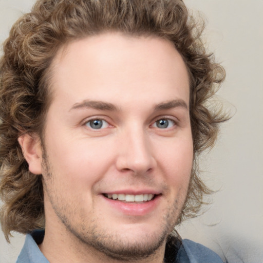 Joyful white young-adult male with medium  brown hair and brown eyes