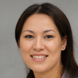 Joyful asian young-adult female with long  brown hair and brown eyes