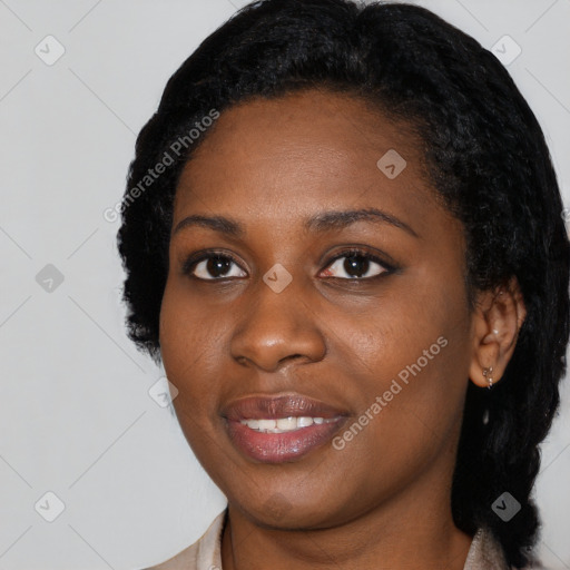 Joyful black young-adult female with long  black hair and brown eyes