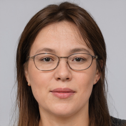 Joyful white adult female with long  brown hair and grey eyes