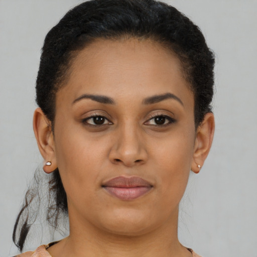 Joyful black young-adult female with short  brown hair and brown eyes