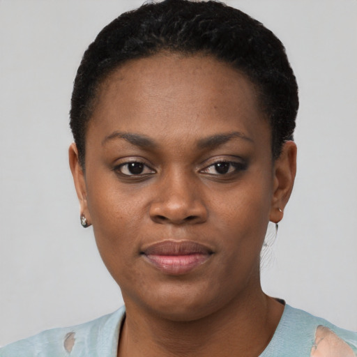 Joyful black young-adult female with short  black hair and brown eyes