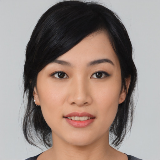 Joyful asian young-adult female with medium  black hair and brown eyes