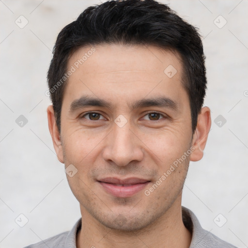 Joyful white young-adult male with short  black hair and brown eyes