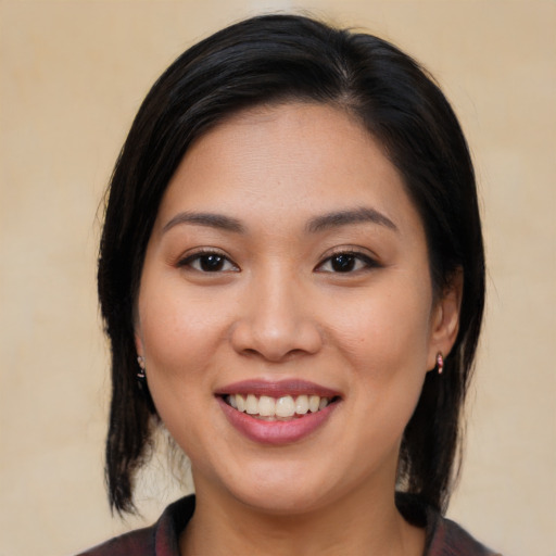 Joyful asian young-adult female with medium  brown hair and brown eyes