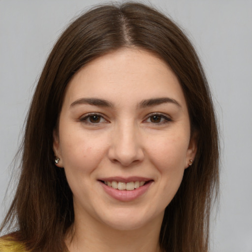 Joyful white young-adult female with long  brown hair and brown eyes