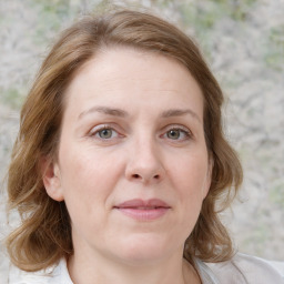 Joyful white young-adult female with medium  brown hair and blue eyes