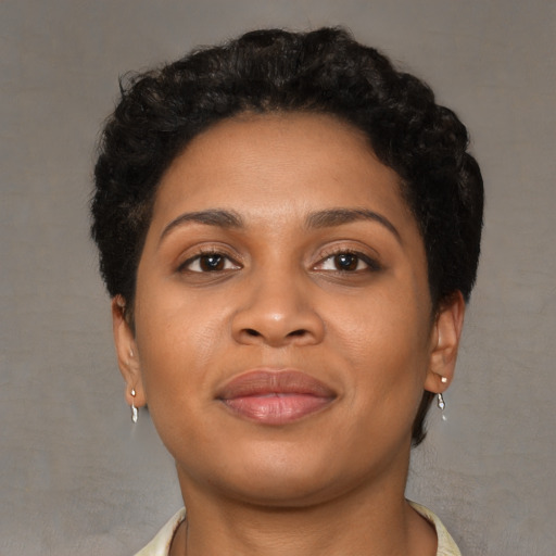 Joyful black young-adult female with short  brown hair and brown eyes