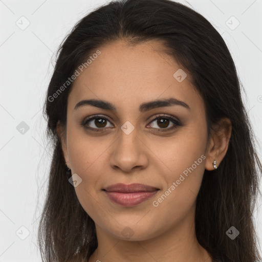 Joyful latino young-adult female with long  brown hair and brown eyes