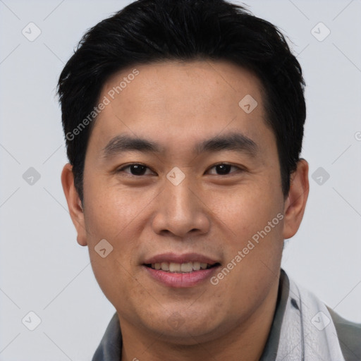 Joyful asian young-adult male with short  black hair and brown eyes