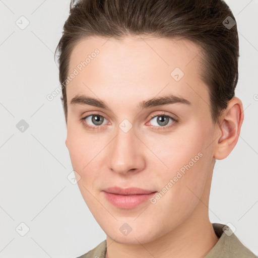 Joyful white young-adult female with short  brown hair and brown eyes